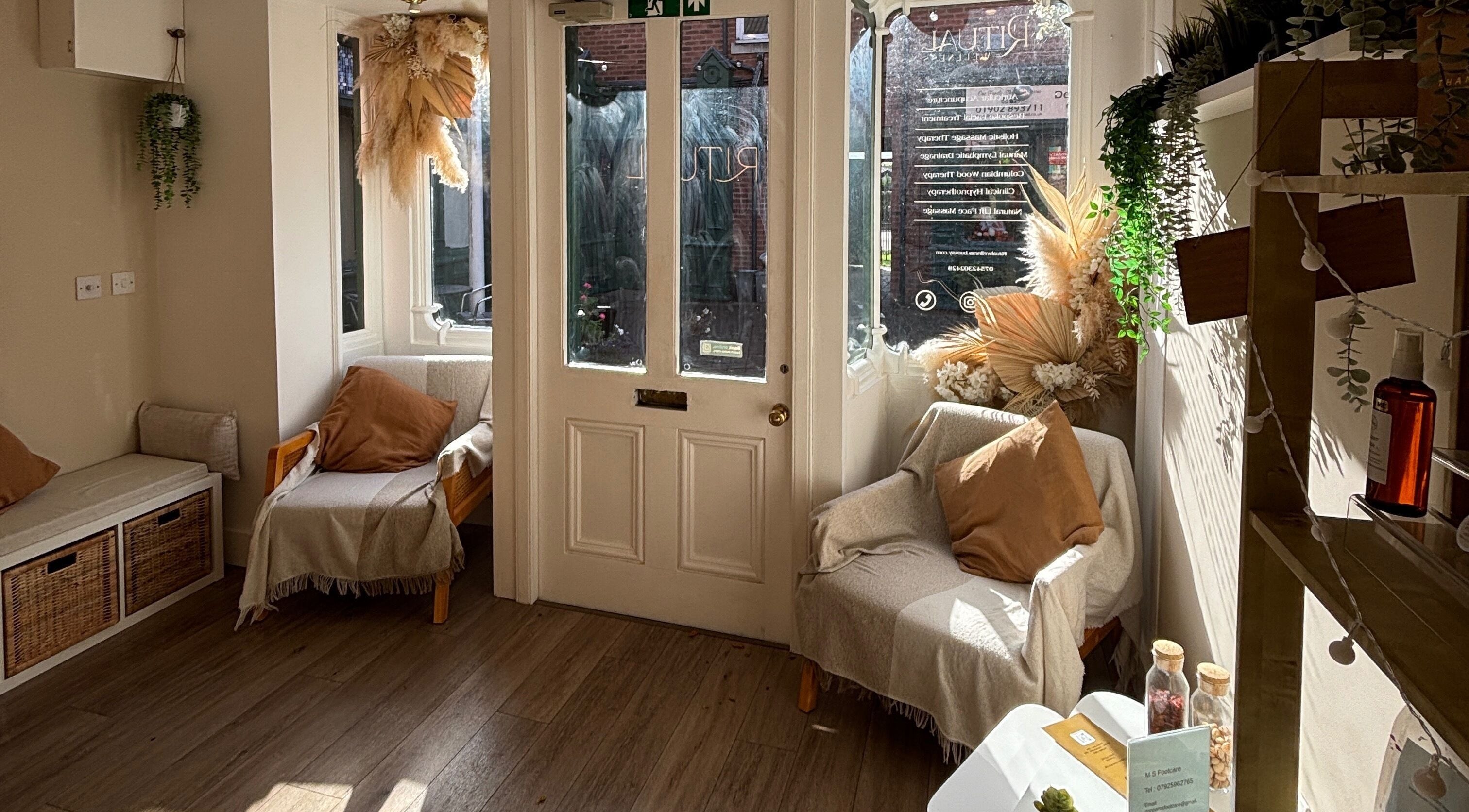 Amber Rose Cosmetics cozy entrance lounge in Wombourne, England, GB with warm decor and natural light.