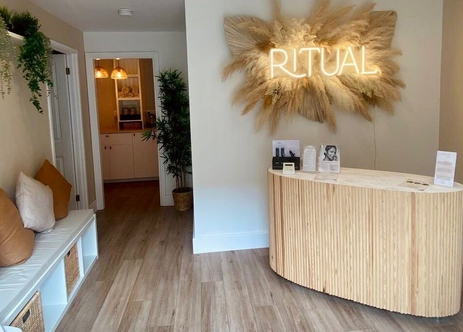 Trendy reception at Amber Rose Cosmetics, Wombourne, England, GB with a chic 'RITUAL' sign and wood decor.