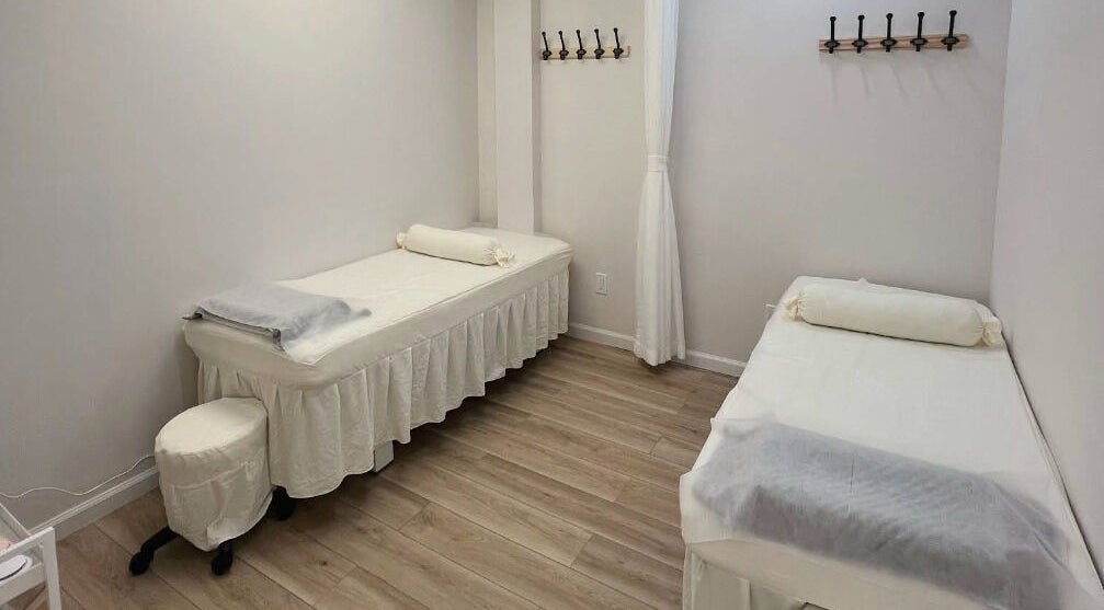 Relaxing treatment room at Hi Lash Bar, Huntington, New York, US with two massage beds and soothing decor.