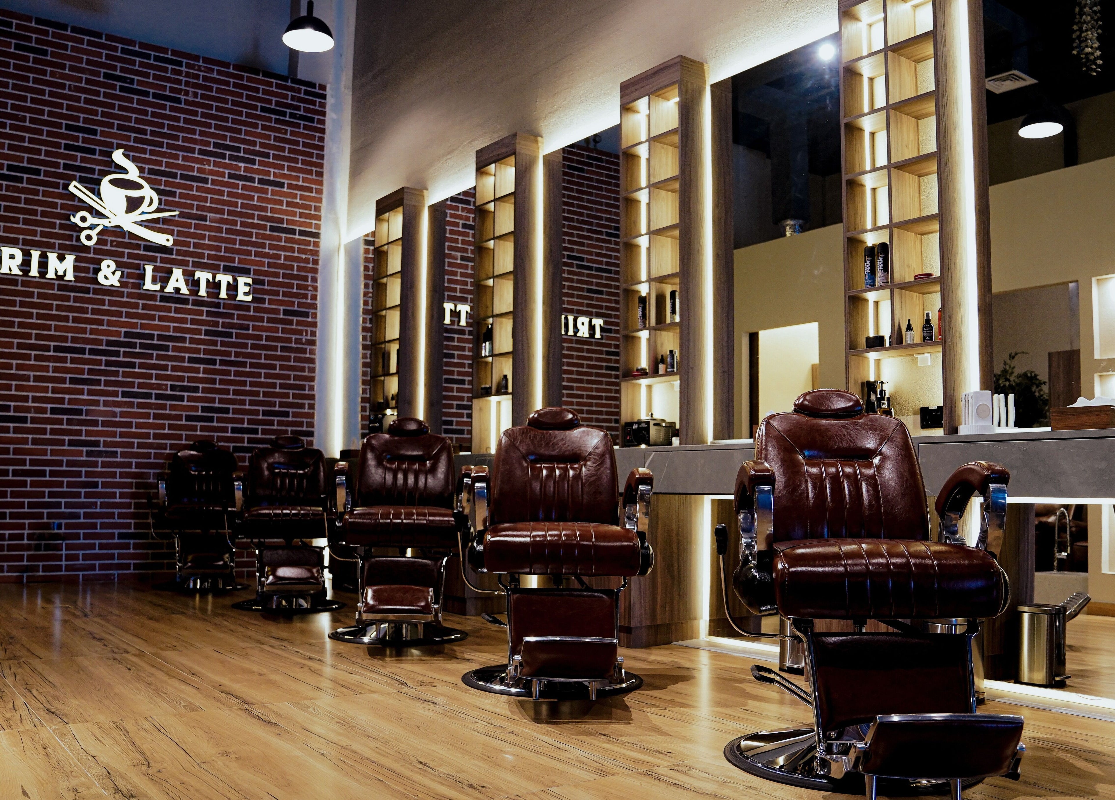 Luxe barber chairs in Trim and Latte Men Hairdressing Trimming and Styling, Abu Dhabi, AE, with stylish decor.