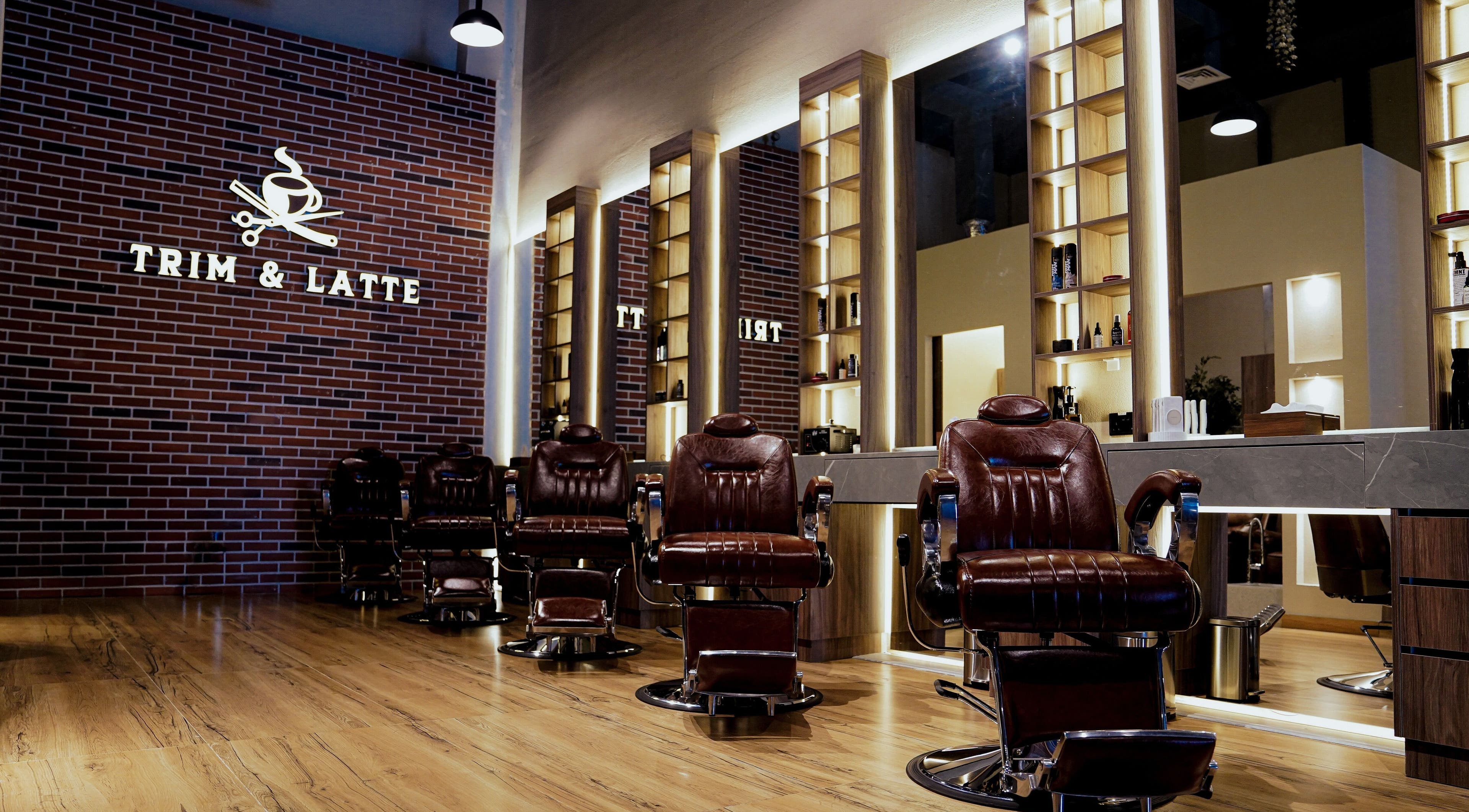 Luxe barber chairs in Trim and Latte Men Hairdressing Trimming and Styling, Abu Dhabi, AE, with stylish decor.