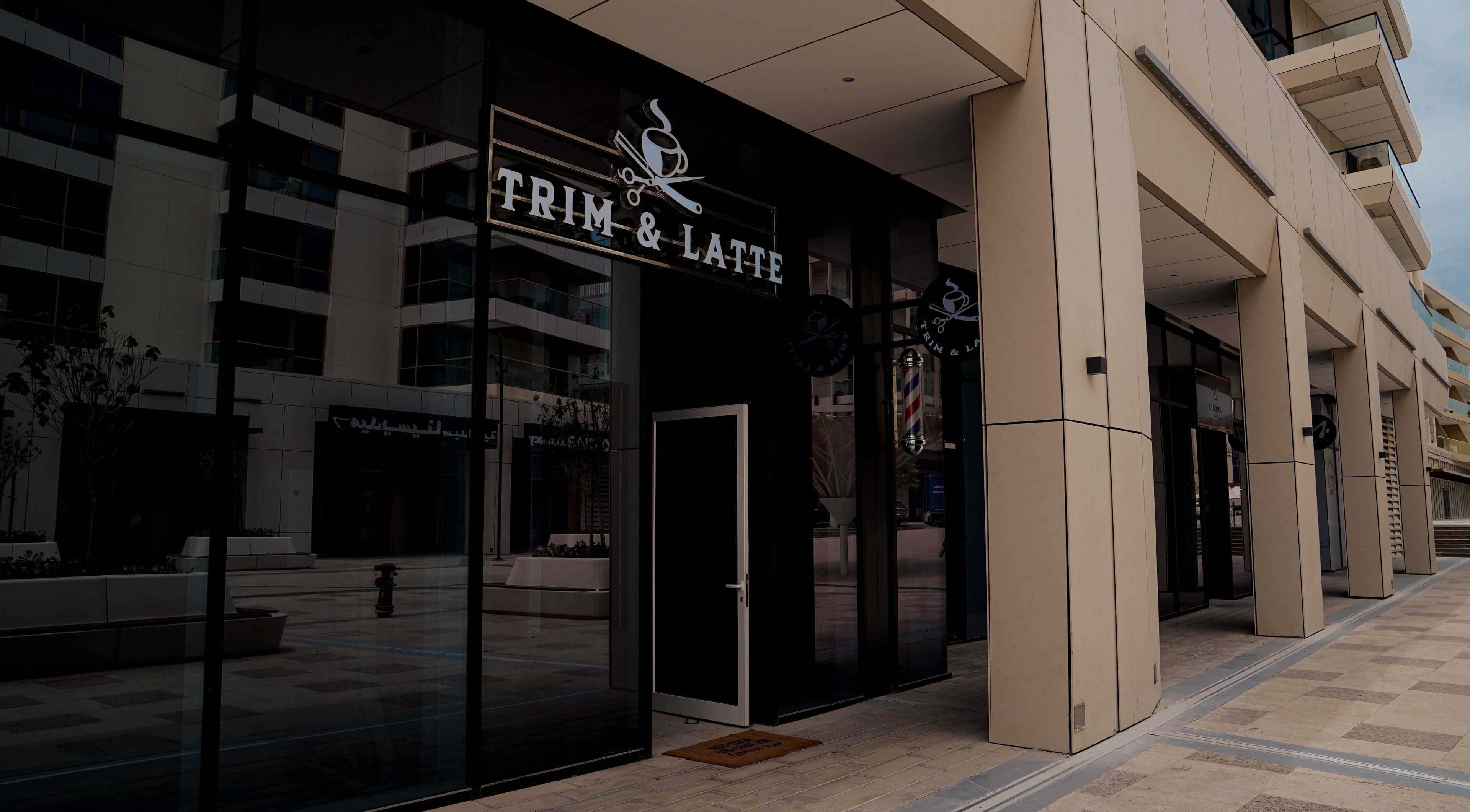 Entrance of Trim and Latte Men Hairdressing Trimming and Styling in Abu Dhabi, AE, featuring sleek design.