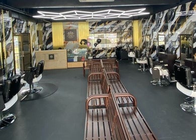 Modern interior of Mco Barbershop D'anjung in Shah Alam, Selangor, MY with sleek barber chairs and unique wall designs.