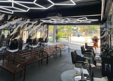 Modern interior of Mco Barbershop D'anjung in Shah Alam, Selangor, MY with stylish seating and decor.
