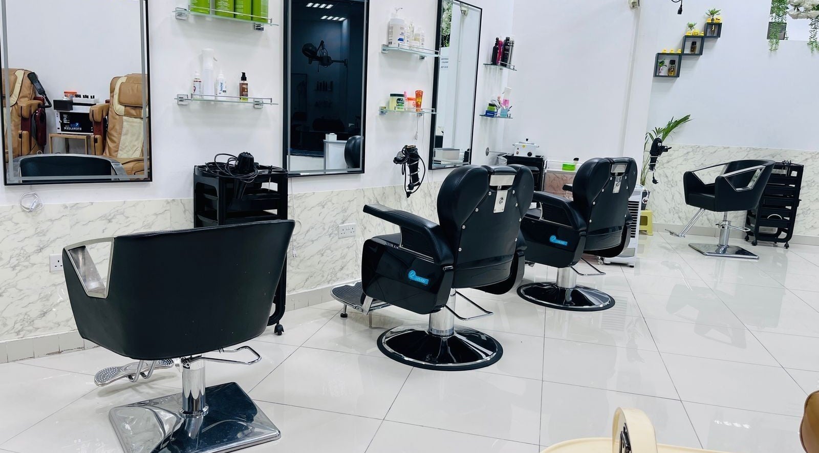 Interior of Beige Beauty Center featuring sleek styling chairs in G_st=iw, Sharjah, AE.
