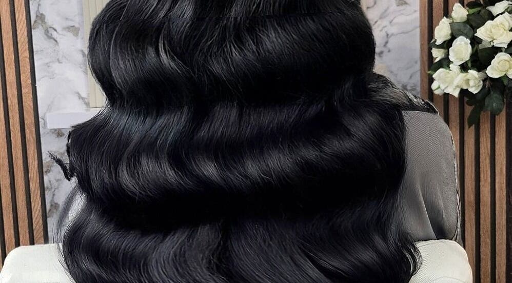 Lustrous black hair extensions at Deluxe Aurora Hair Extensions, Stoke-on-Trent, England, GB, exhibited in elegant waves.