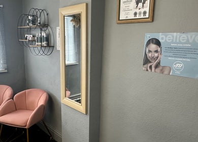 Elegant waiting area at The Aesthetic Edit, Mileham, England, GB, featuring pink chairs and wall mirror.