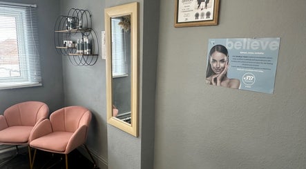 Elegant waiting area at The Aesthetic Edit, Mileham, England, GB, featuring pink chairs and wall mirror.
