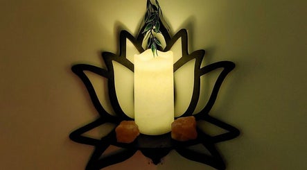 Serene candle on lotus holder at Tranquility Well-Being, Cromer, England, GB, for a calming atmosphere.