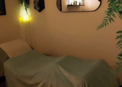 Relaxing massage room at Tranquility Well-Being, Cromer, England. Soft lighting and calming decor.