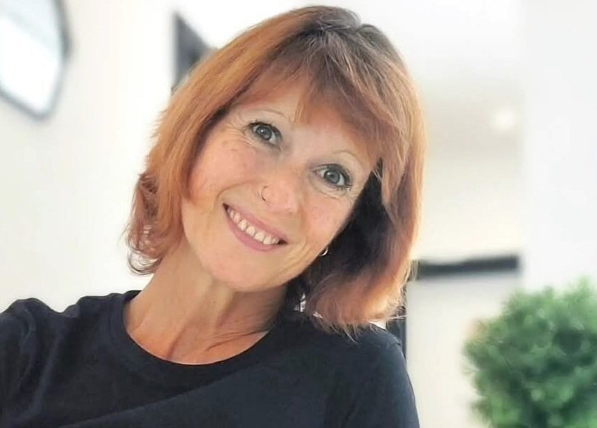 Friendly staff member at Tranquility Well-Being, Cromer, England, GB offering a welcoming smile.