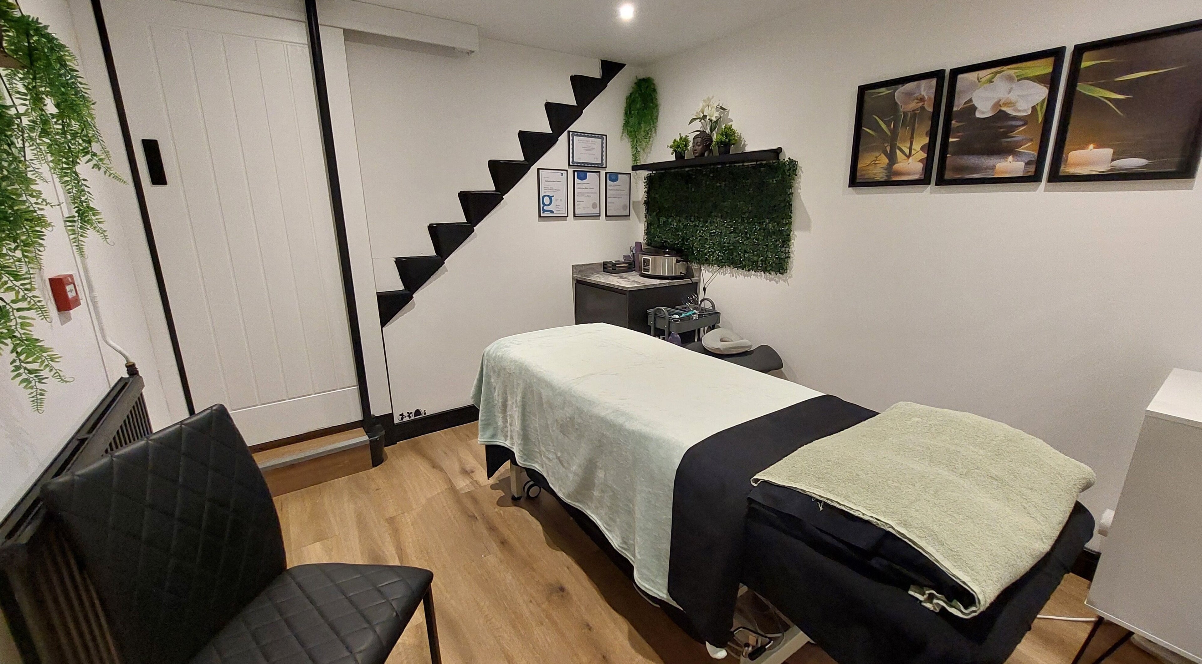 Relaxing massage room at Tranquility Well-Being, Cromer, England, GB with decor and treatment table.