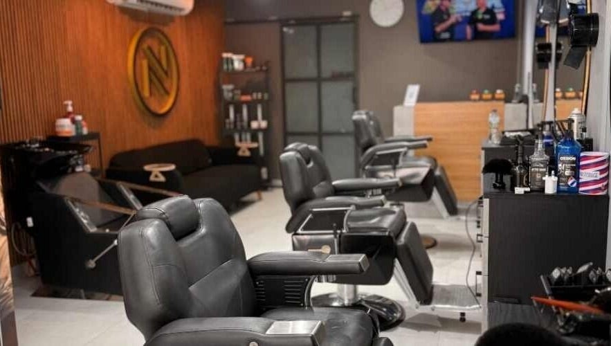 Modern interior of Noir Salon & Spa in Zinj, Muḥāfaẓat Al-ʿāṣimah, BH, featuring stylish black chairs.