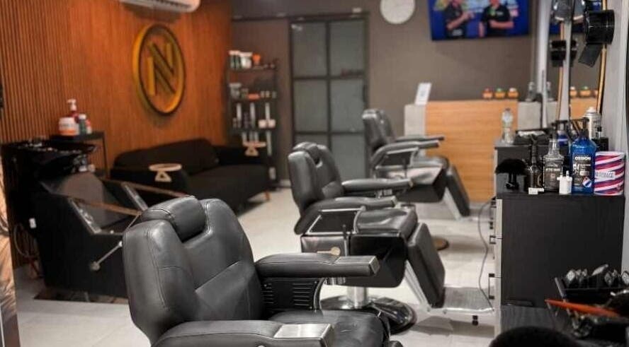Modern interior of Noir Salon & Spa in Zinj, Muḥāfaẓat Al-ʿāṣimah, BH, featuring stylish black chairs.