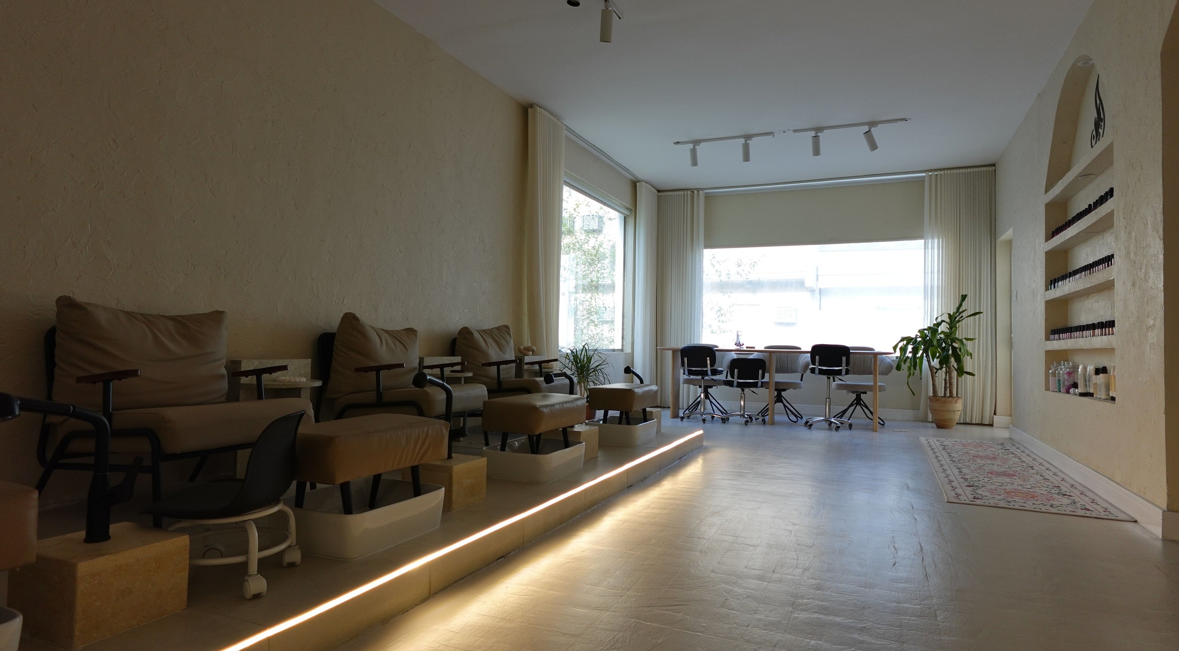 Relaxing pedicure area at Eileen Spa, Al Khobar, Eastern Province, SA with soft lighting and plush chairs.