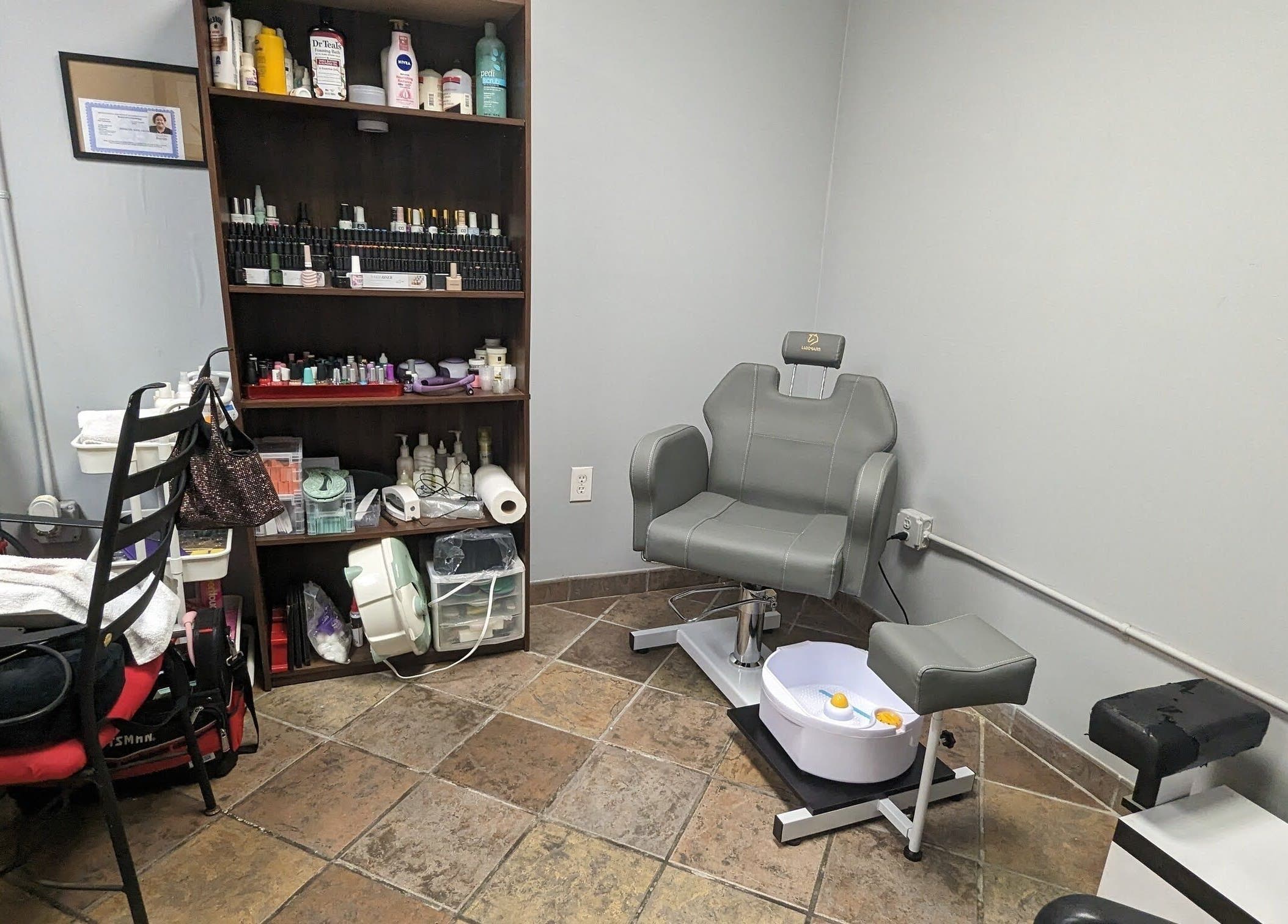 Comfortable pedicure chair and colorful nail supplies at Sparkles Gel & Nail Art Studio, Camden, South Carolina, US.