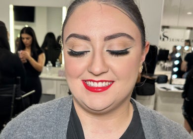 Client with glamorous makeup by Naomi Lee Makeup, Catherine Field, New South Wales, AU. Red lips and winged eyeliner.
