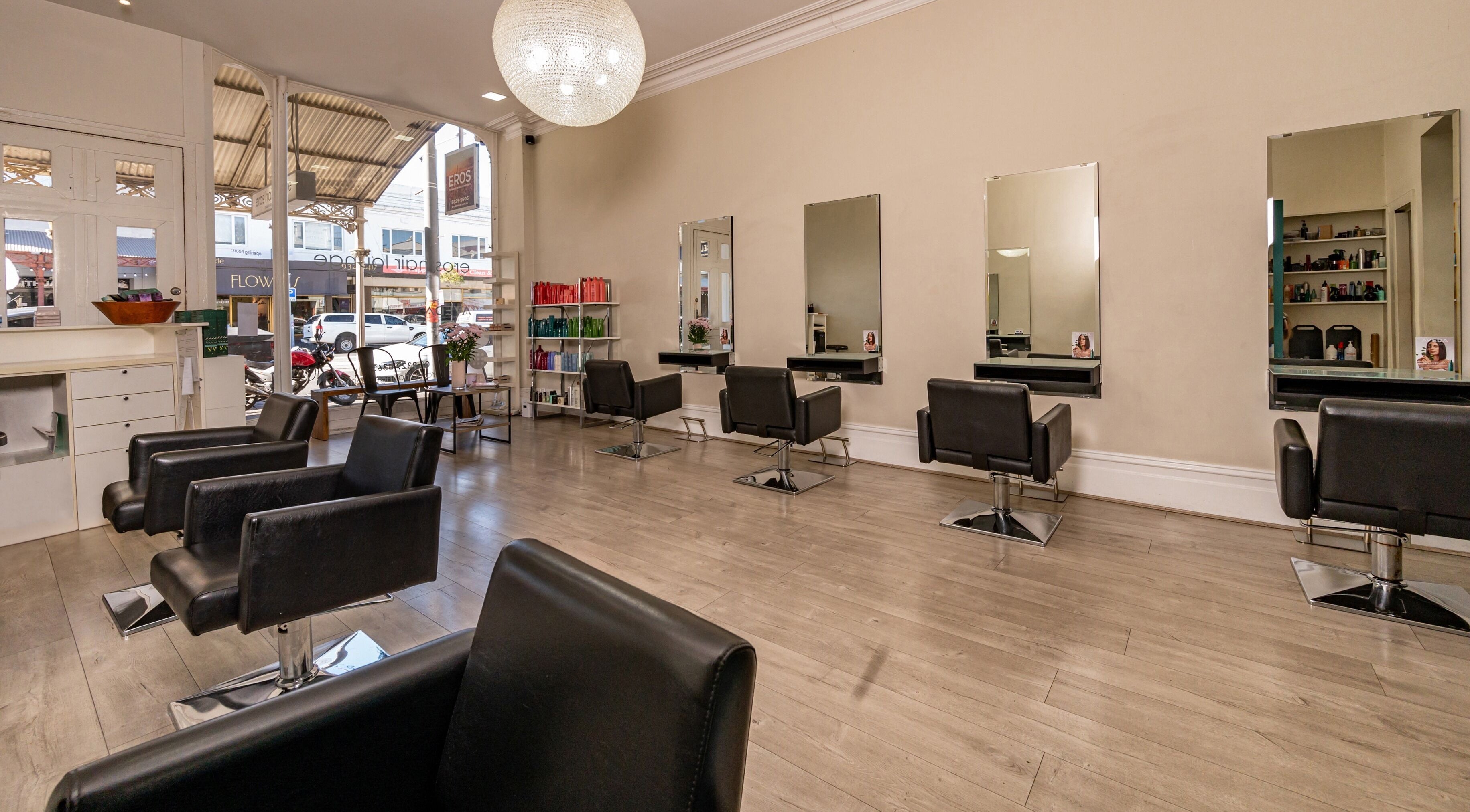 Eros Hair Lounge interior with stylish chairs and mirrors in Melbourne, Victoria, AU.