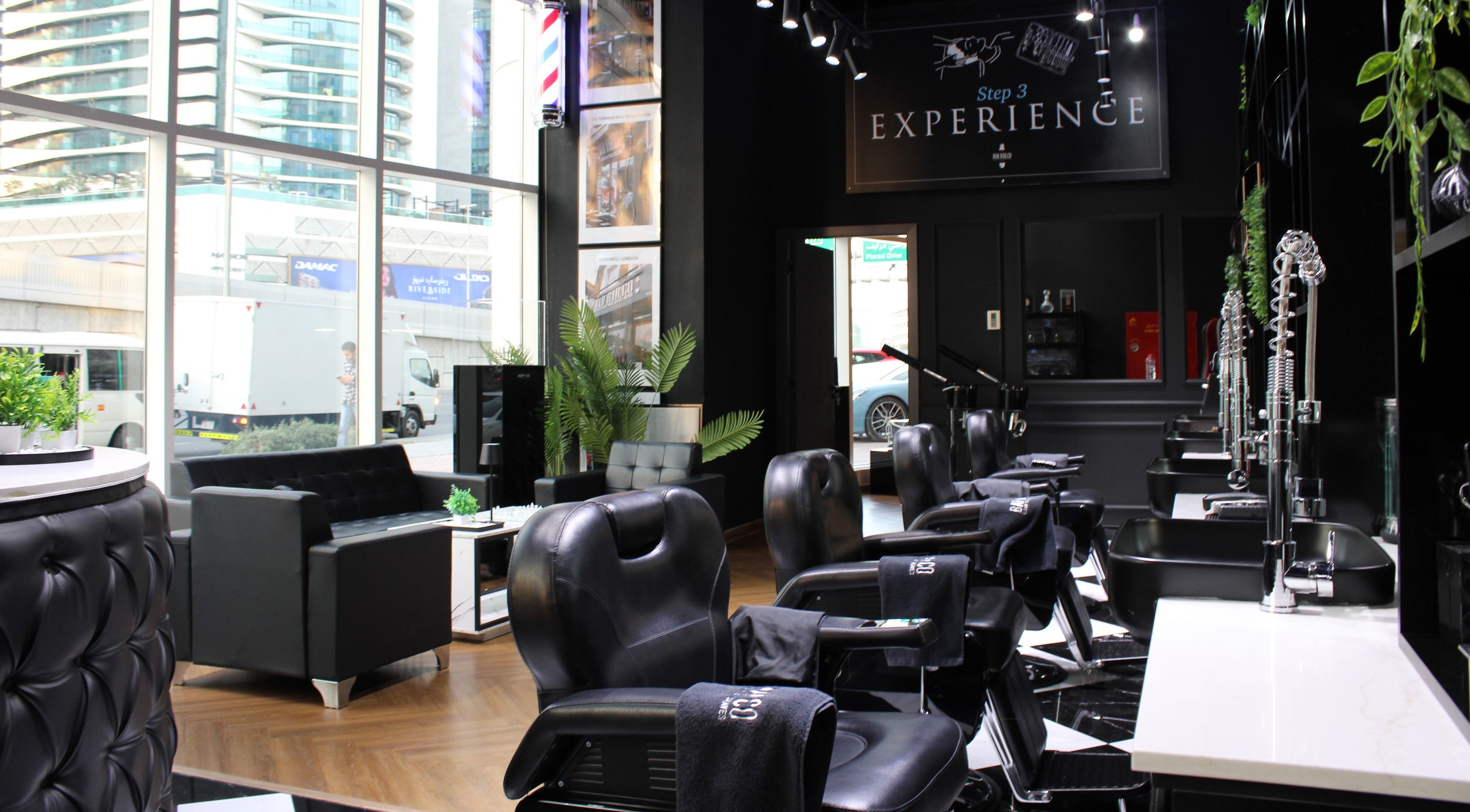 Chic interior of Barbarco, Dubai, Dubai, AE, featuring modern salon chairs and lush greenery.