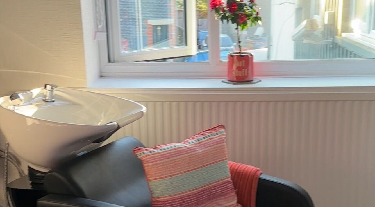 Comfortable salon chair and wash basin at Bel's Hair, Cardiff, Wales, GB. Inviting atmosphere with decor.