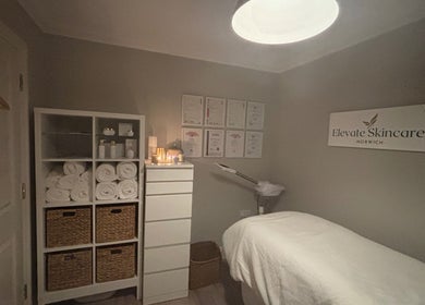 Cozy interior of Elevate Skincare Norwich with treatment bed, towels, and soothing decor in Norwich, England, GB.