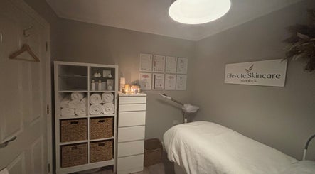 Cozy interior of Elevate Skincare Norwich with treatment bed, towels, and soothing decor in Norwich, England, GB.
