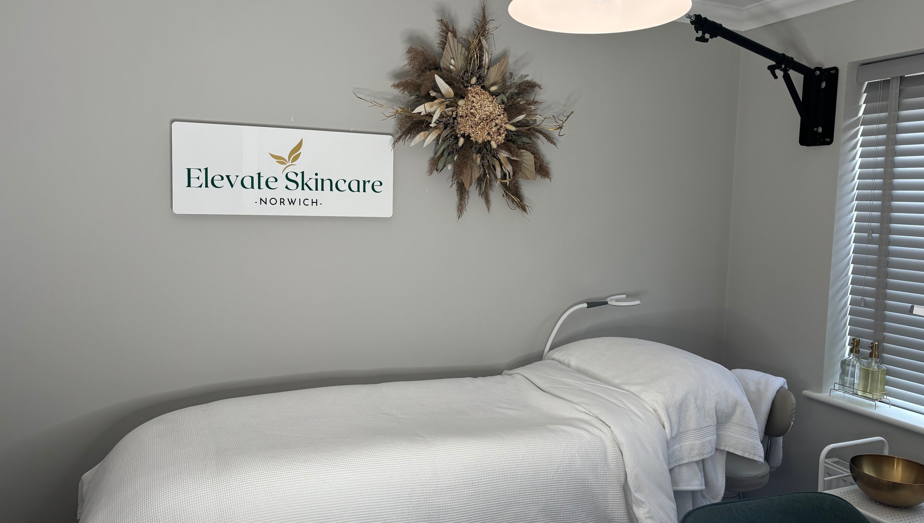 Elevate Skincare Norwich's calming treatment room featuring a massage bed and elegant decor in Norwich, England, GB.