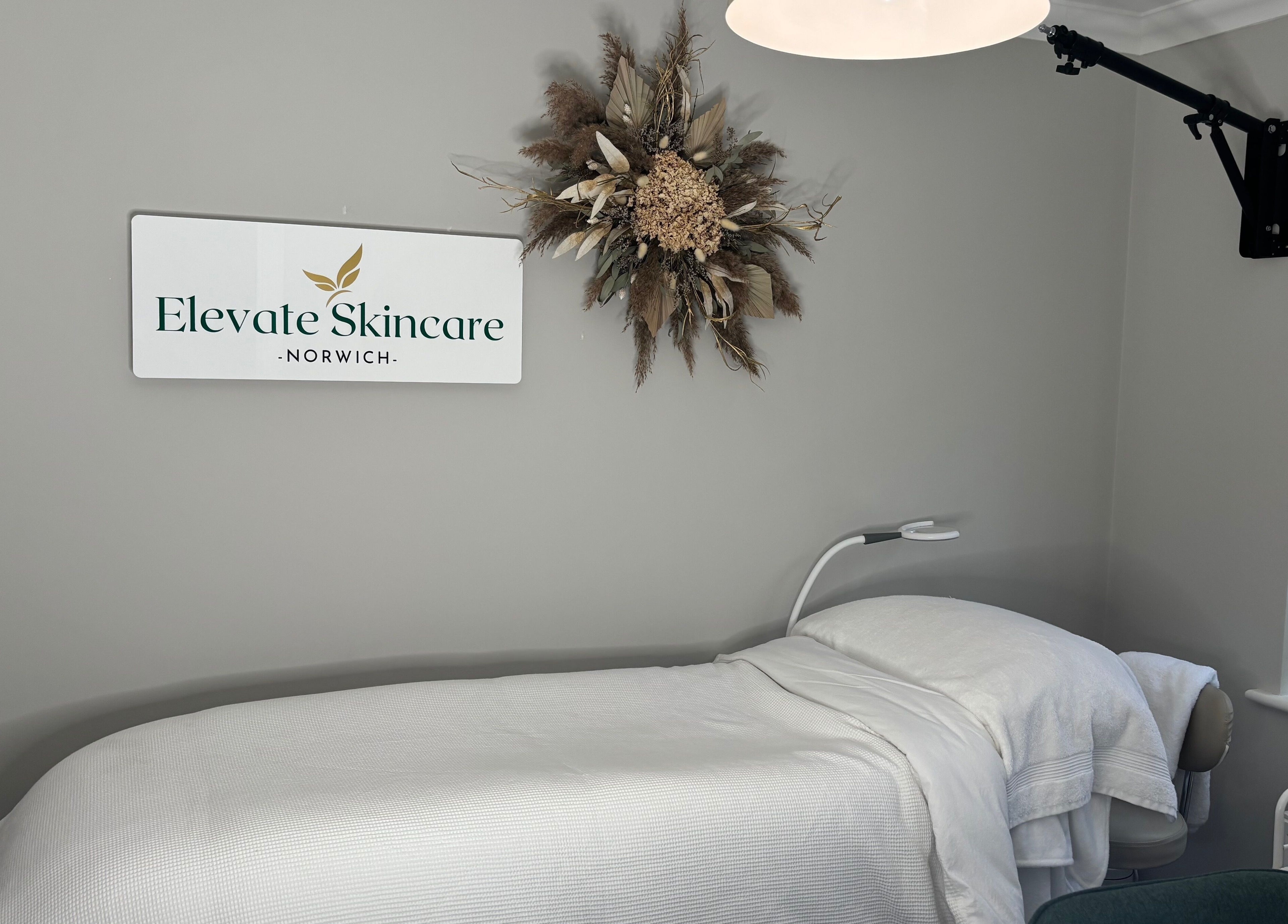 Elevate Skincare Norwich's calming treatment room featuring a massage bed and elegant decor in Norwich, England, GB.
