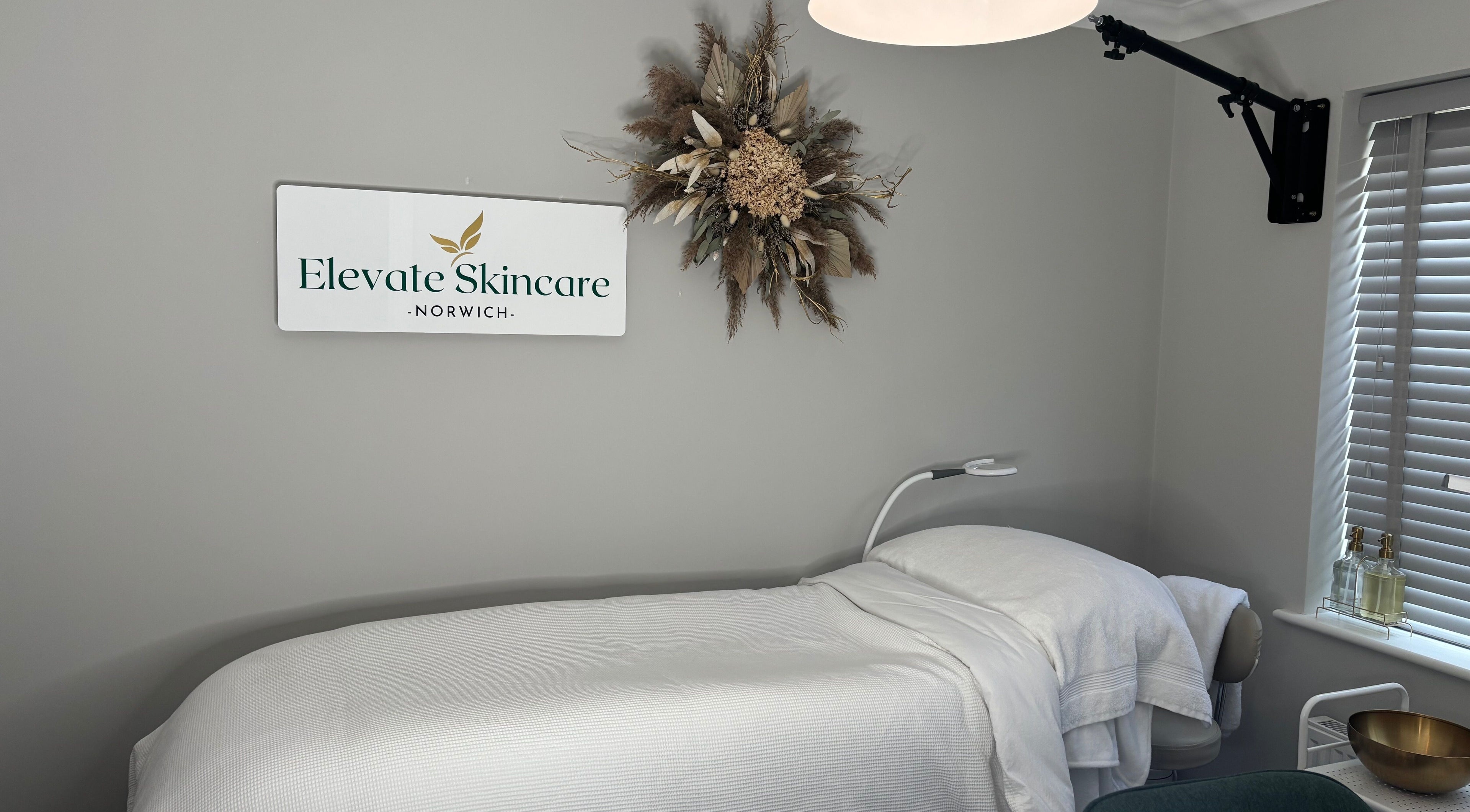 Elevate Skincare Norwich's calming treatment room featuring a massage bed and elegant decor in Norwich, England, GB.