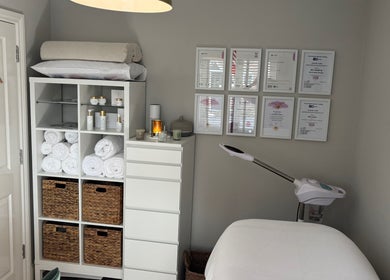 Elevate Skincare Norwich offers a tranquil treatment room in Norwich, England, GB with certificates and products displayed.