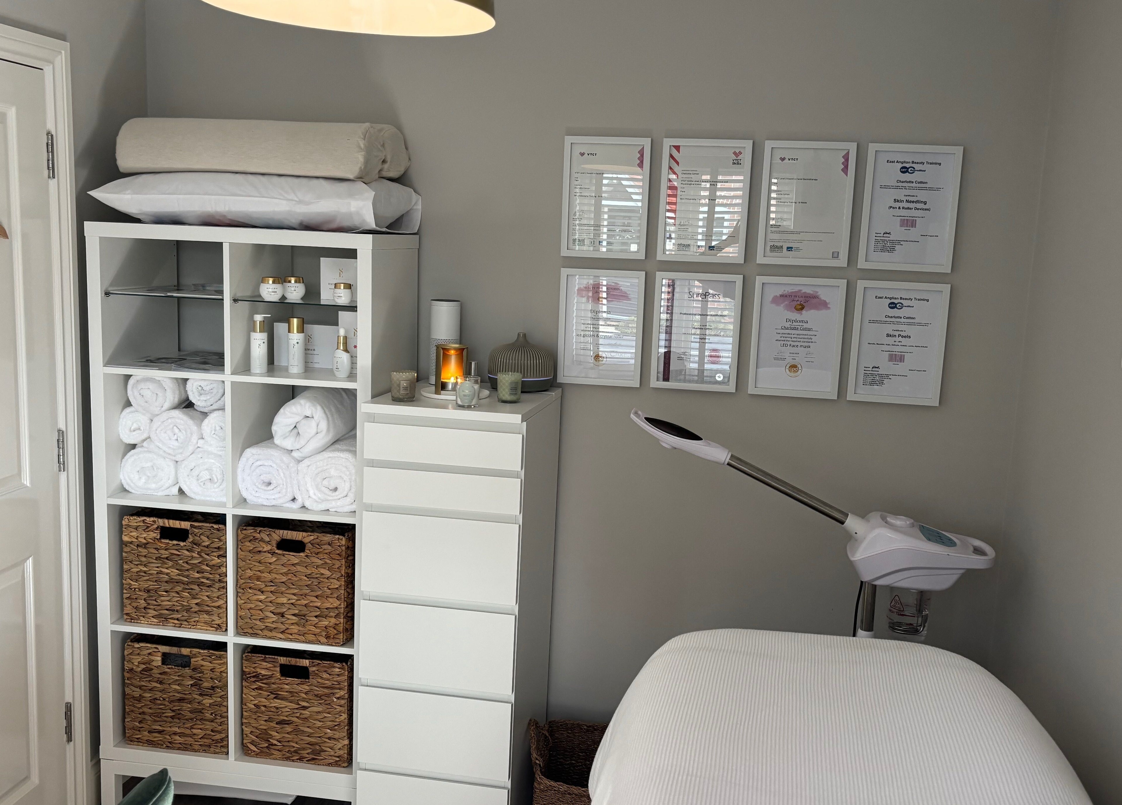 Elevate Skincare Norwich offers a tranquil treatment room in Norwich, England, GB with certificates and products displayed.