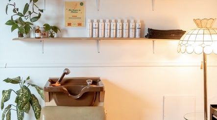 Stylish salon corner at Les Coupes de Mathieu, Montréal, Québec. Features elegant shelves and wash basin.