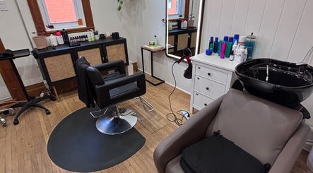 Chic hair studio at Les Coupes de Mathieu in Montréal, Québec, CA with styling chair and salon products.
