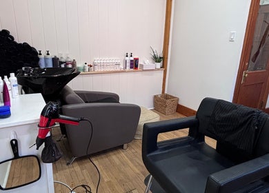 A chic salon interior at Les Coupes de Mathieu, Montréal, Québec, CA, featuring a styling chair and hair products.