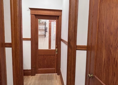 Classic wooden hallway at Les Coupes de Mathieu in Montréal, Québec, CA showcasing refined craftsmanship.