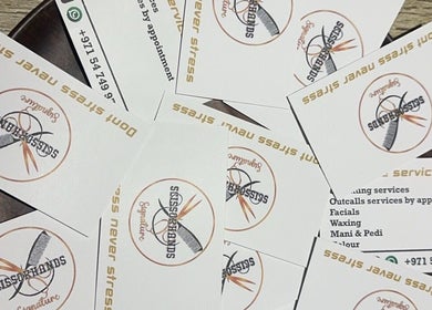 Scissorhandssignature business cards scattered, showcasing logo in Dubai, Dubai, AE.