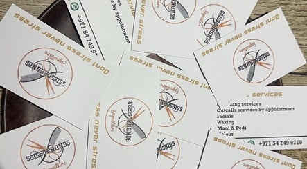 Scissorhandssignature business cards scattered, showcasing logo in Dubai, Dubai, AE.