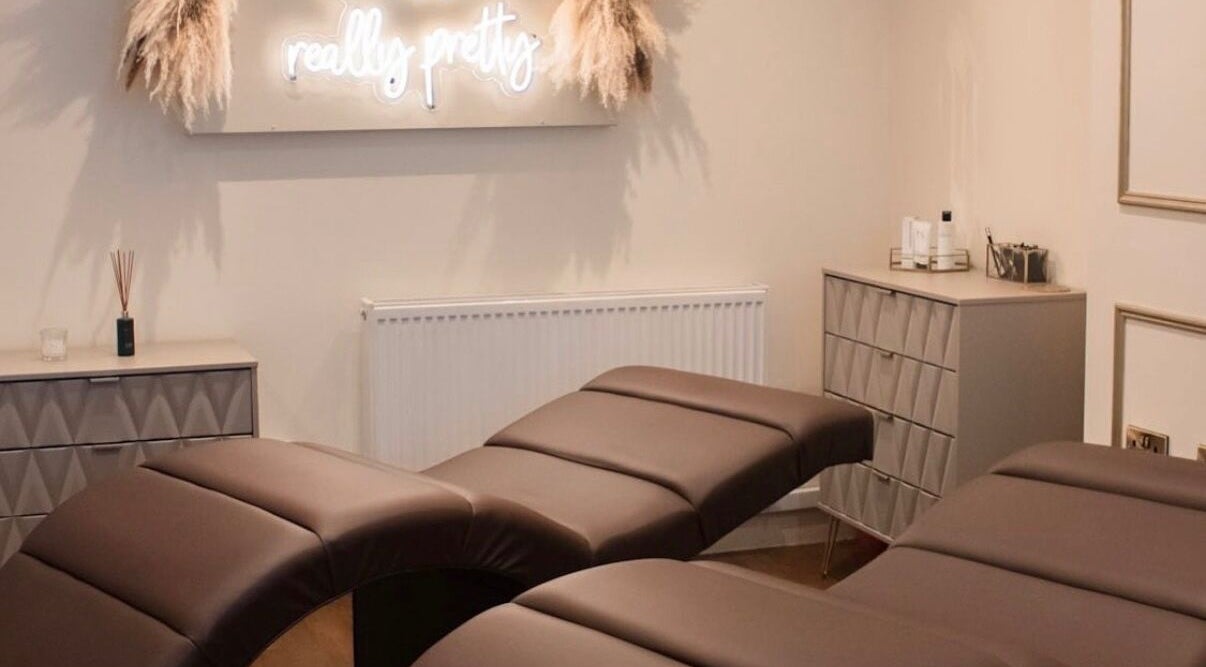 Relaxing treatment room at Gloss’d, Bangor, Wales, GB, featuring comfortable massage beds and calming decor.