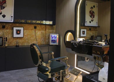 Blade and Fade barbershop interior in Riyadh, Riyadh Province, SA, featuring vintage decor and modern barber chairs.