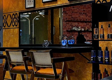 Modern interior of Blade and Fade in Riyadh, Riyadh Province, SA, featuring stylish chairs and product display.