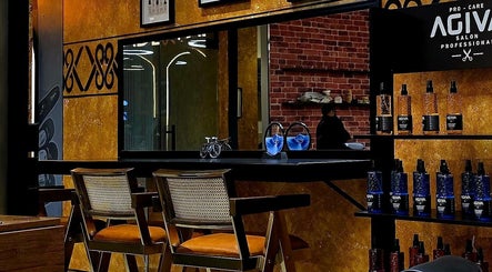 Modern interior of Blade and Fade in Riyadh, Riyadh Province, SA, featuring stylish chairs and product display.