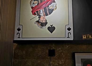 Chic wall art of a vintage playing card at Blade and Fade, Riyadh, Riyadh Province, SA.