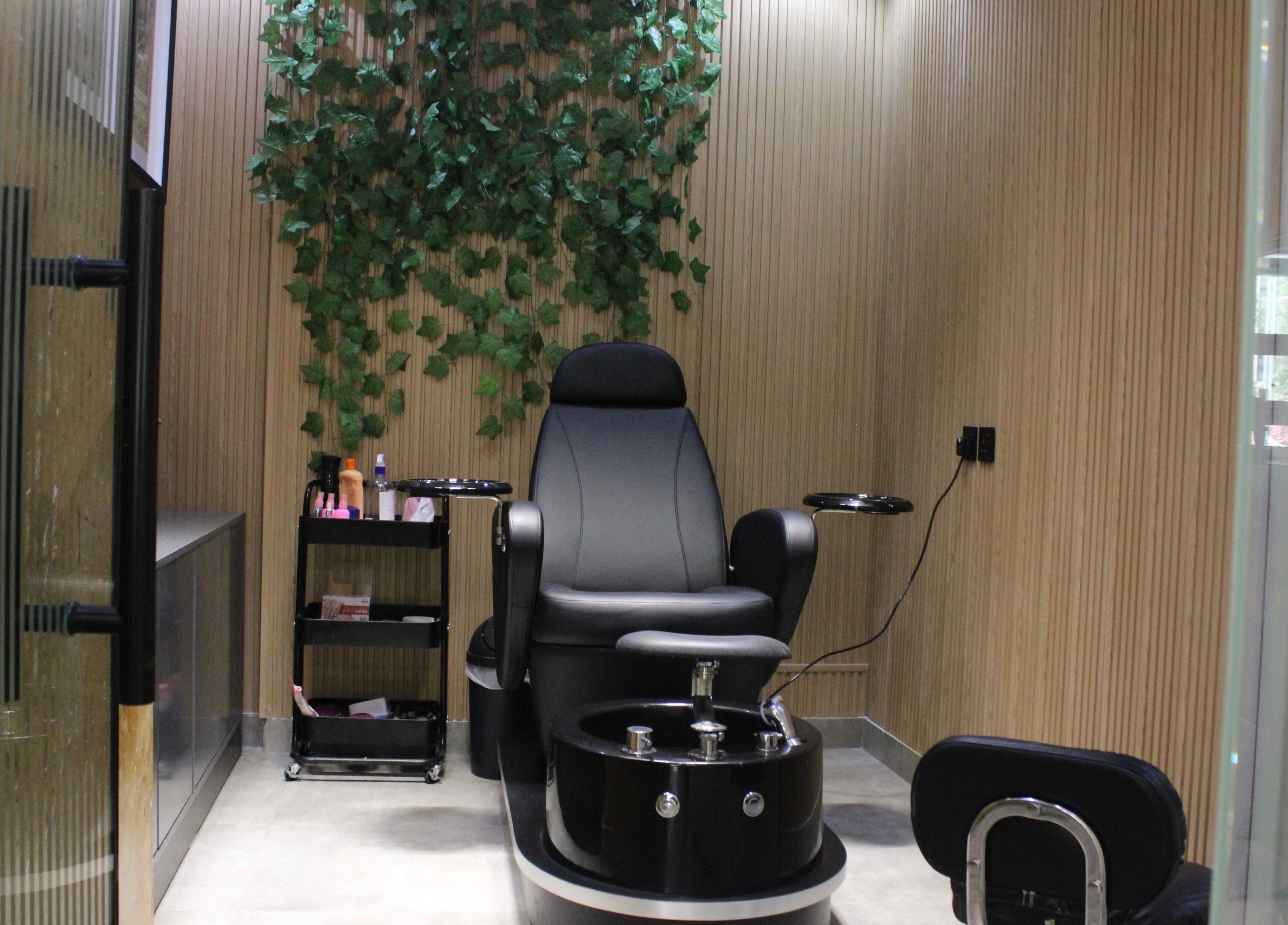 Luxury pedicure chair at Blade and Fade, Riyadh, Riyadh Province, SA; lush greenery and serene setting.