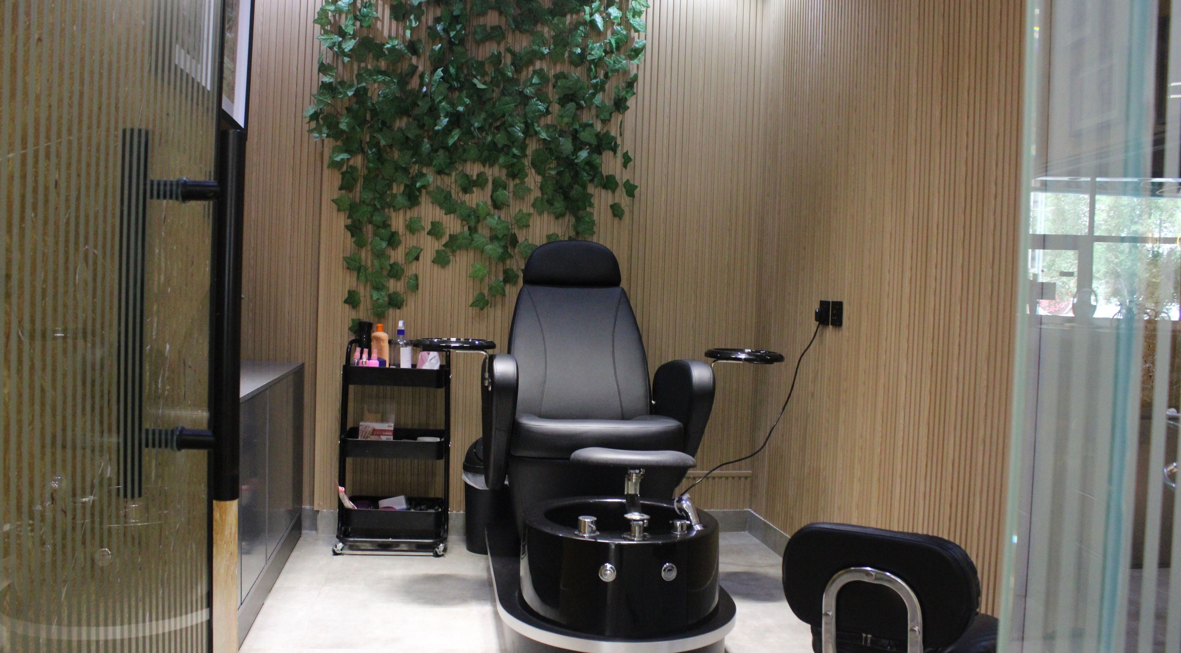 Luxury pedicure chair at Blade and Fade, Riyadh, Riyadh Province, SA; lush greenery and serene setting.