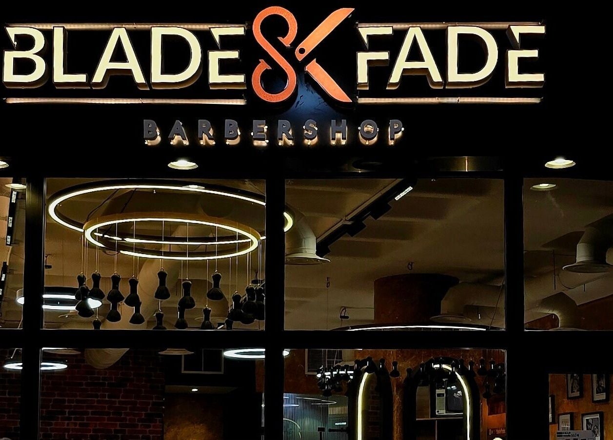 Exterior of Blade and Fade barbershop in Riyadh, Riyadh Province, SA, showcasing modern lighting.