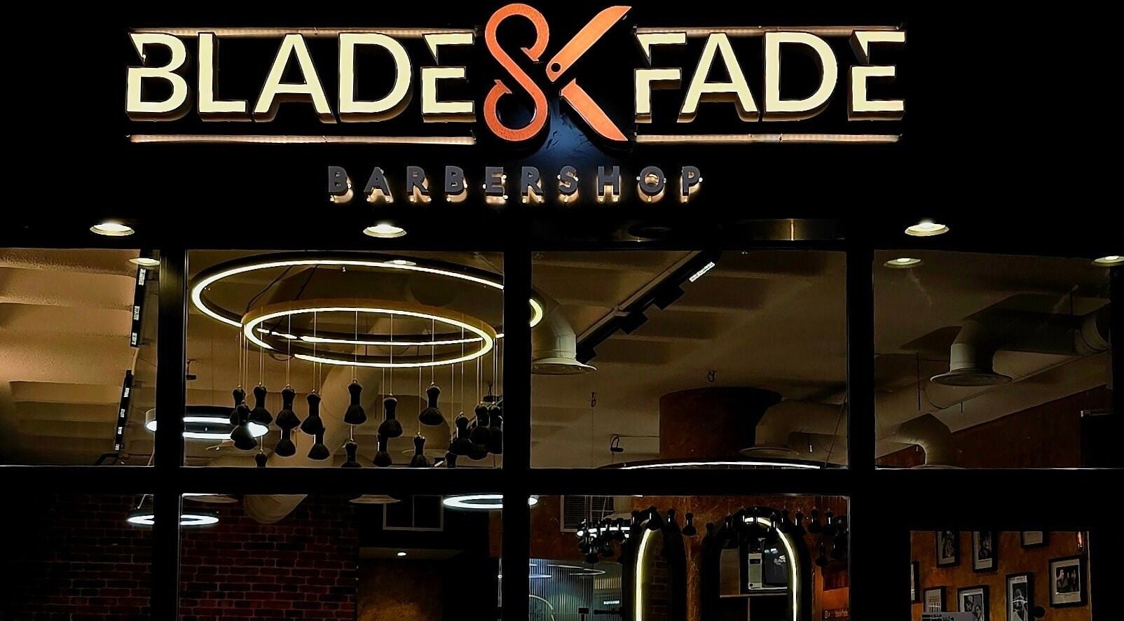Exterior of Blade and Fade barbershop in Riyadh, Riyadh Province, SA, showcasing modern lighting.