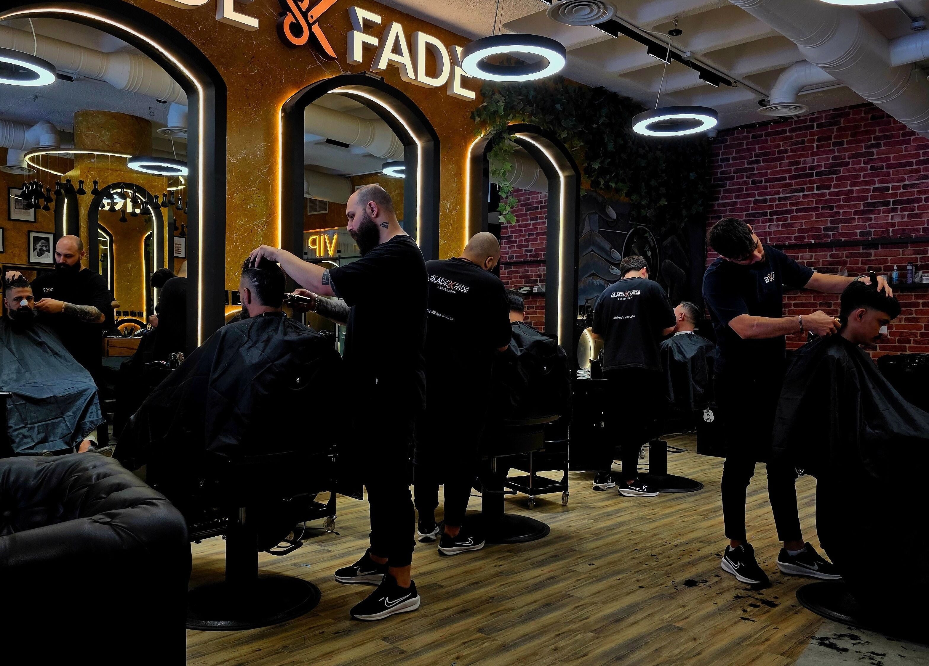 Stylish barbers at work in Blade and Fade, Riyadh, Riyadh Province, SA, creating trendy haircuts.