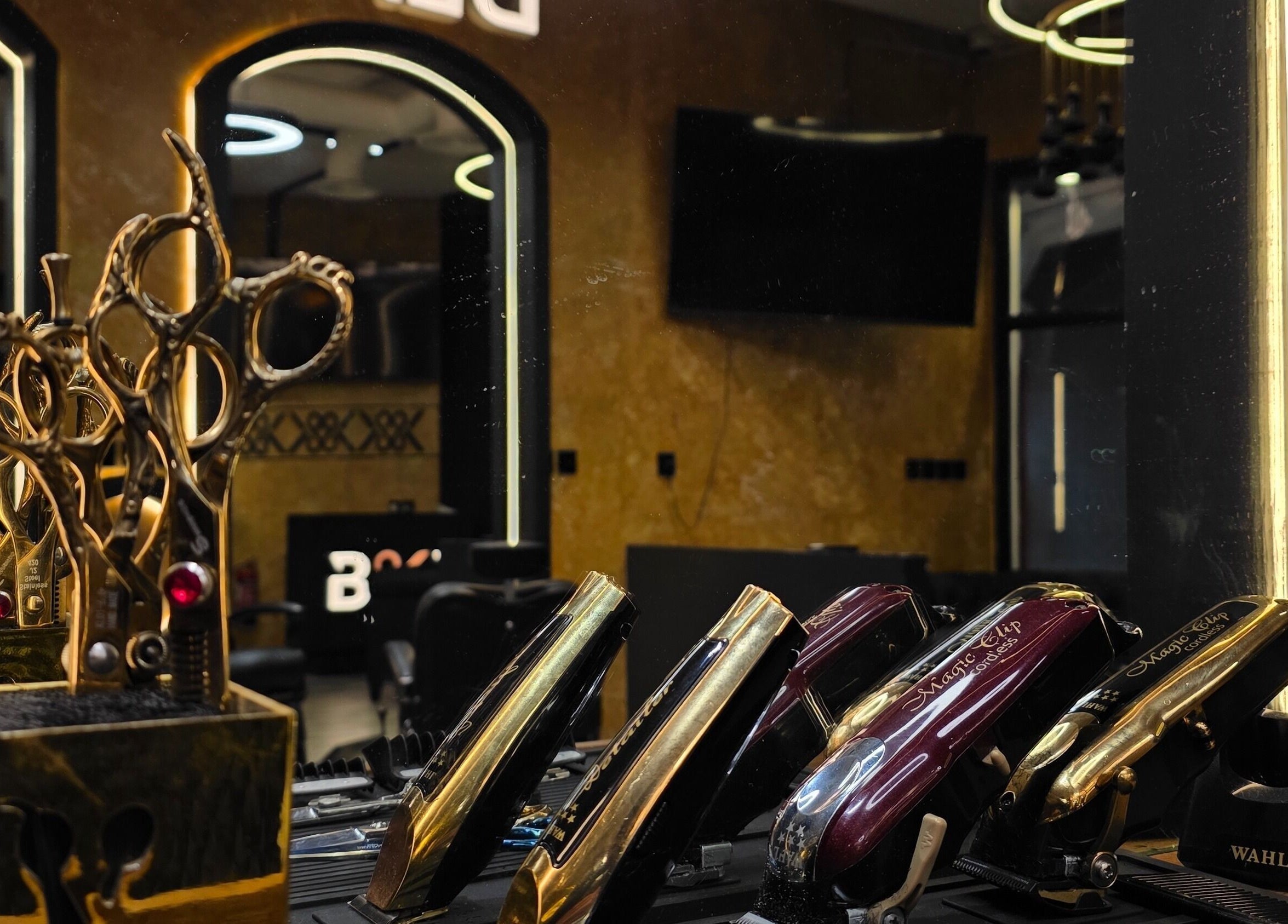 Blade and Fade salon's elegant gold scissors and clippers in Riyadh, Riyadh Province, SA.