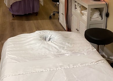 Relaxing massage room at NY Massage at Riverview in Gibsonton, Florida, US with a white massage table.