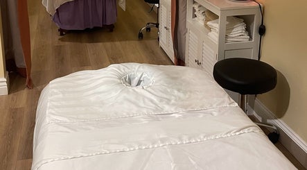 Relaxing massage room at NY Massage at Riverview in Gibsonton, Florida, US with a white massage table.
